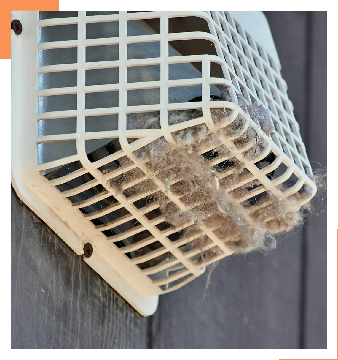 Clogged exterior dryer vent cover filled with lint buildup.