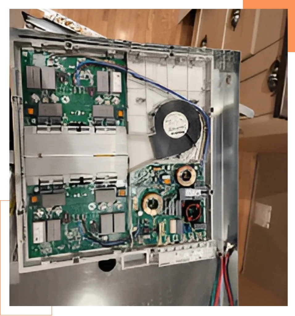 Internal electronic components and circuit boards of household appliance during repair.