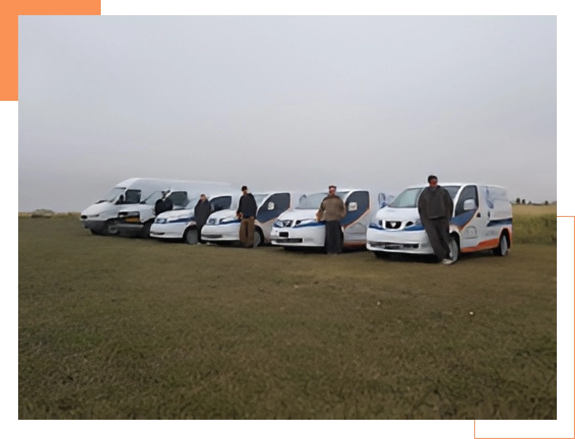 Appliance repair team standing beside branded service vans in open field.